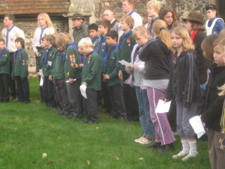 Cub Scouts and their leaders, Tony and Vicky Tierney, together with lots of other units of the Wivenhoe Scout & Guide Association attending the Service at the War Memorial. | Peter Hill
