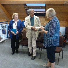 Gill Strudwick, History Group Deputy Chairman who has been leading the Roll of Honour project receiving a cheque for £375 from Frank and Gillian Baker towards the project   | Photo Peter Hill