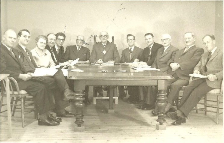 1967 Wivenhoe Urban District Council L – R:  Cllr. Ted Westlake, Cllr.Terry Endean, Cllr. Miss B.A. Grasby, Cllr.  Bill Cracknell, Assistant Clerk Albert Manning, Cllr. Percy Chaney, Cllr. William Loveless, Mr. D.F. Sweeting, Surveyor and Public Health Inspector, Walter Trickett Clerk to the Council, Cllr. D. Bull, Cllr. G. J. James, Cllr. Leslie Kemble. 