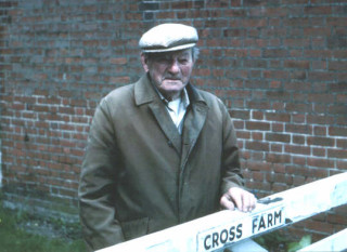 A familiar sight, Claude Watsham standing at the gate to Cross Farm up until the late 1980s. | Photo: Peter Hill