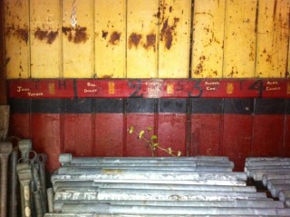 Inside the building with names still visible against the pegs which have been removed | Photo by Toni Stinson